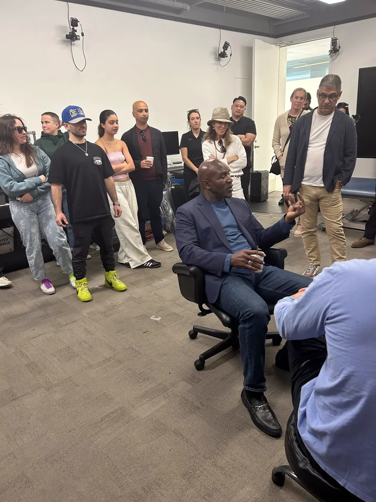 Boxing legend Evander Holyfield giving a talk to attendees and members of the UCLA boxing team
