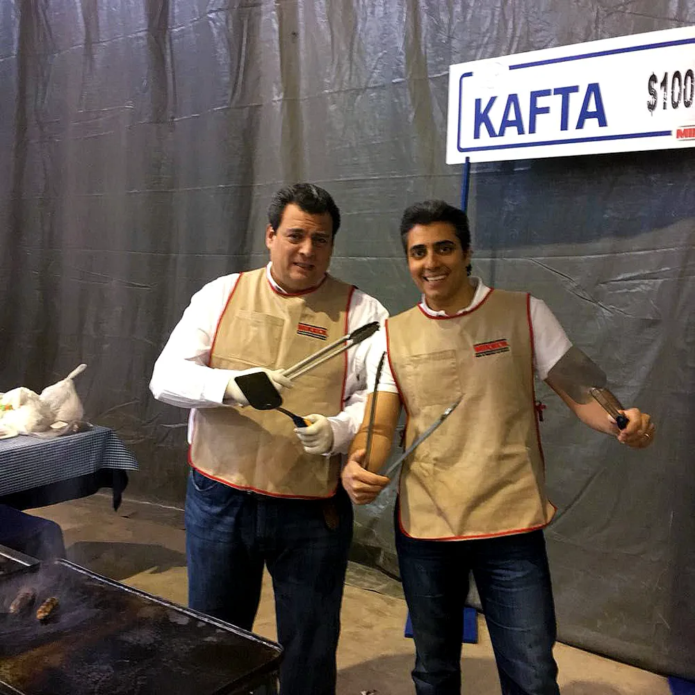 Mauricio Sulaiman posing with another person for the camera at the Falafeada event.