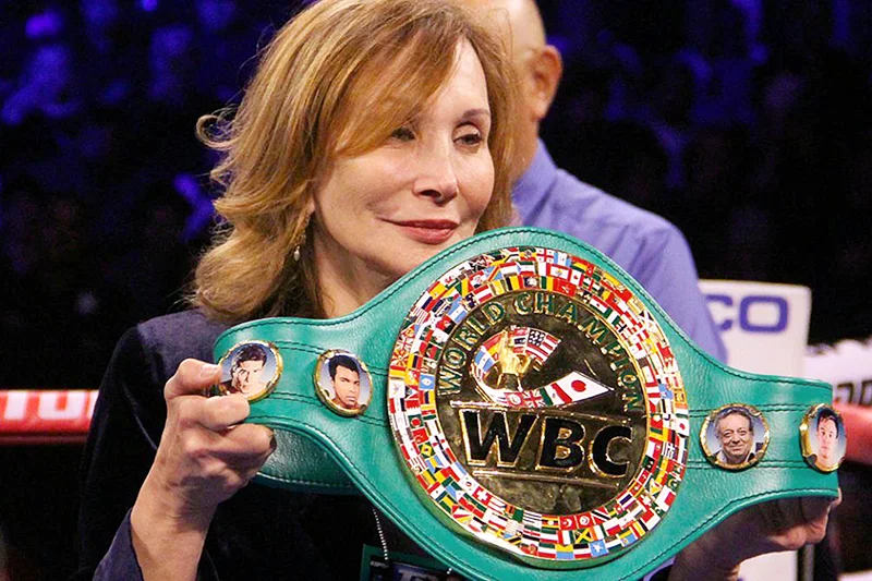 Jill Diamond, international chair of WBC Cares, holding a WBC Champion's belt on the ring