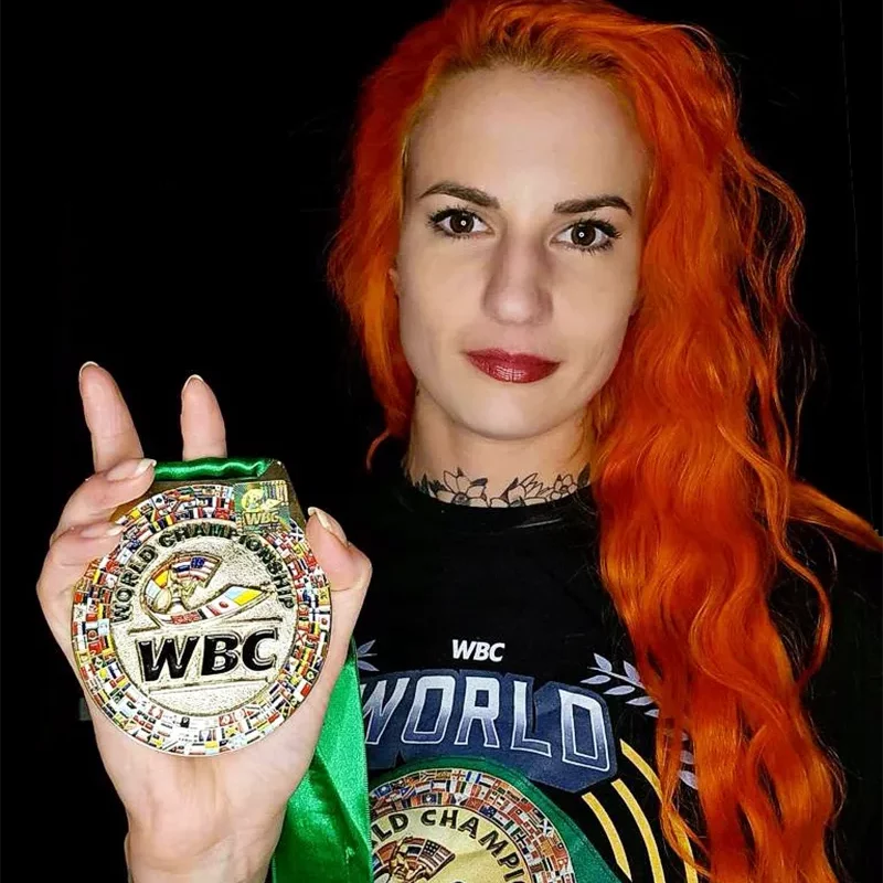 Katia Bissonnette posing with a WBC medal