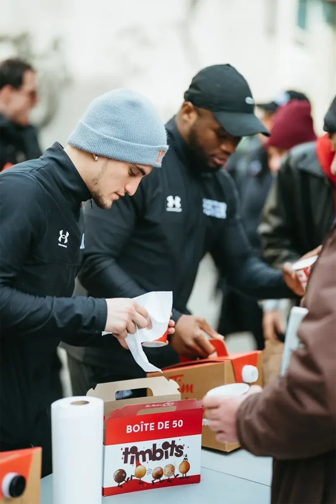 Boxer Christopher Guerrero and Moreno Fendero serving plates for the community
