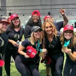 Invited celebrities to the event A Day in the Life, posing for the camera. Dr. Jen Welter, Adrienne Smith, Gracie Martinez, Santa Deck, Sarah Dorough, L3XI. (in no specific order)