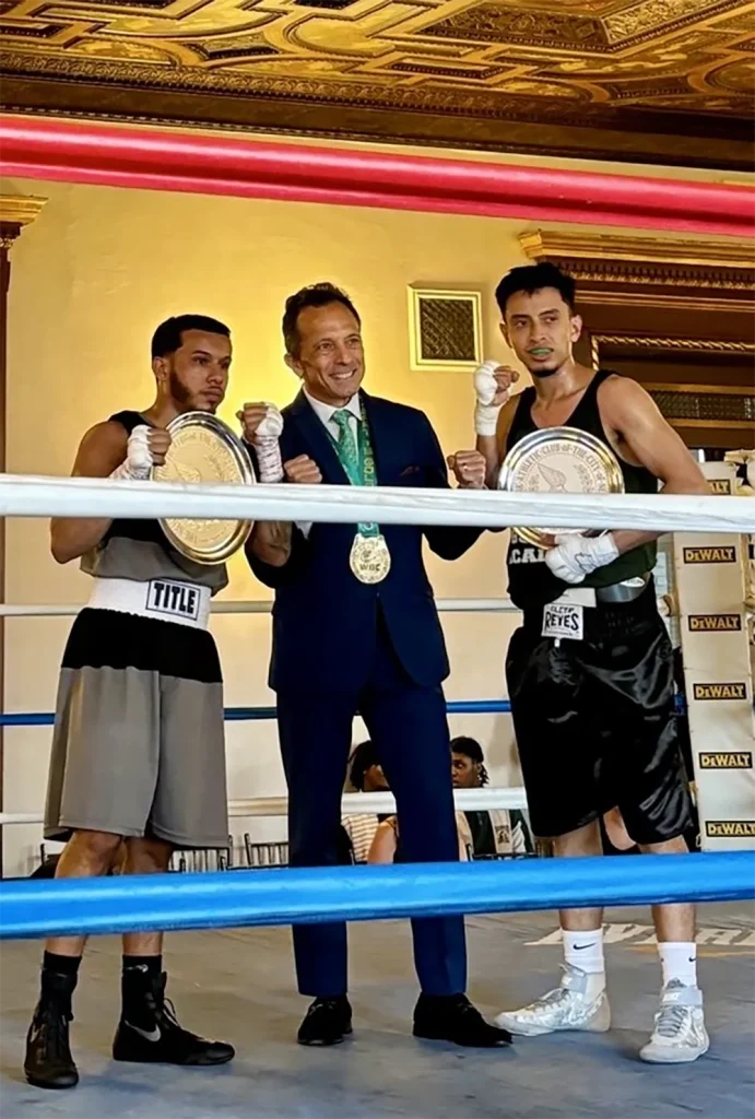 James Mercante with two boxers posing on the ring