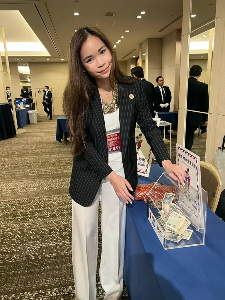 Nabhiraks (Jade) Bhakdibhumi posing for the camera at the fundraising booth