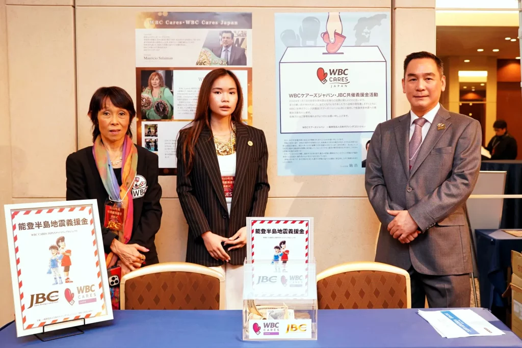 Chisa Yamane, Nabhiraks (Jade) Bhakdibhumi and Col. Thanapol Bhakdibhumi posing for the camera at the fundraising booth